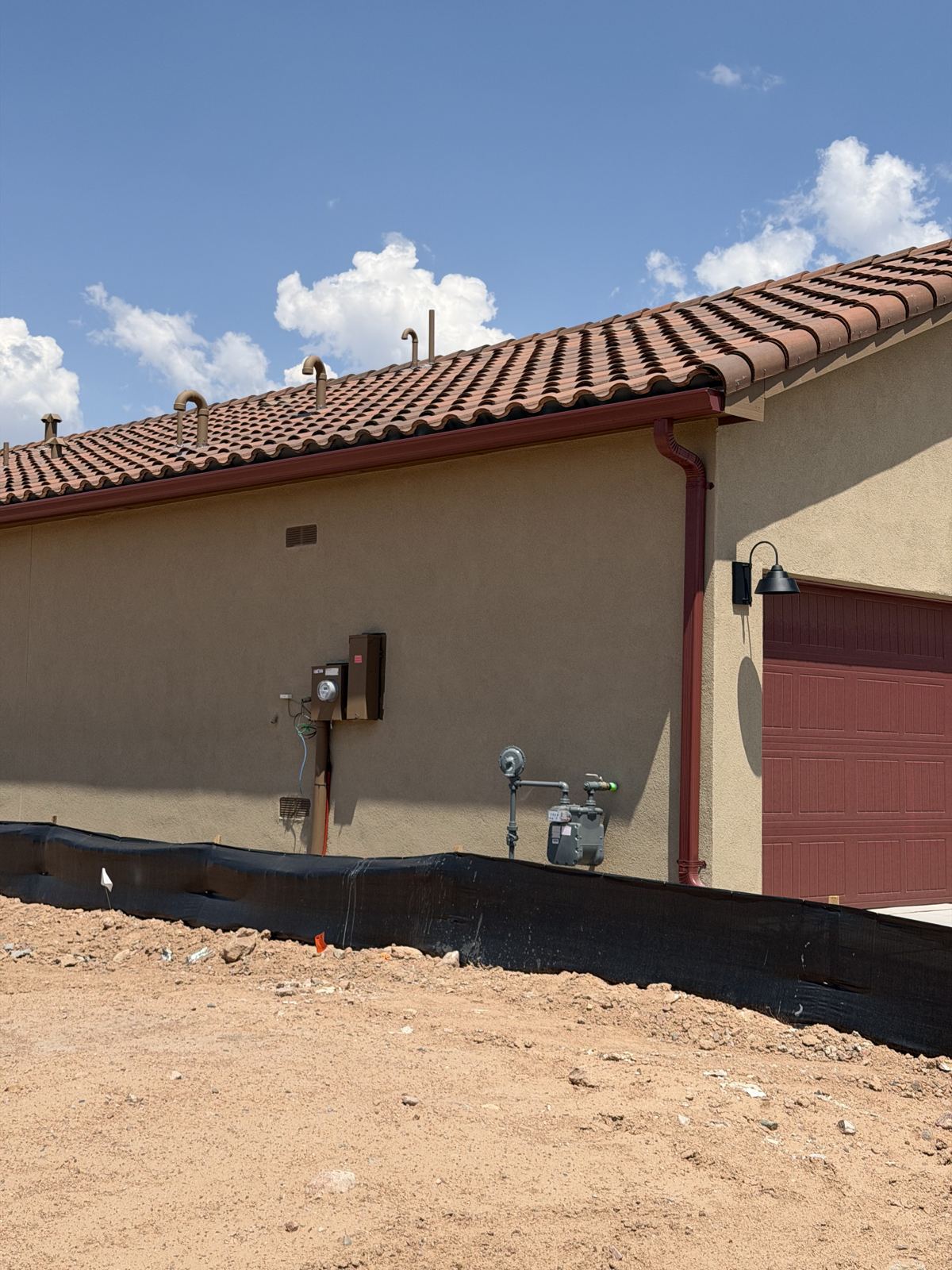Seamless aluminum gutter installed on a stucco tile-roof home in Albuquerque, NM