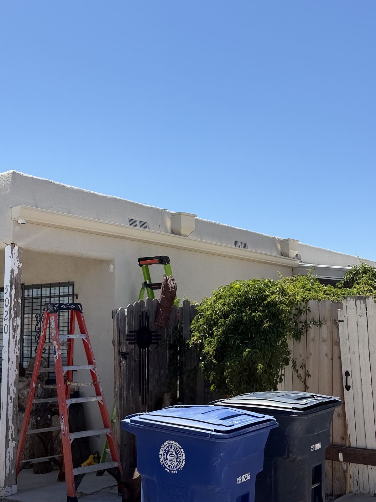 Finished seamless gutter along a stucco roofline